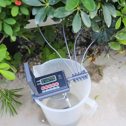 Automatic plant watering system installed in outdoor home garden
