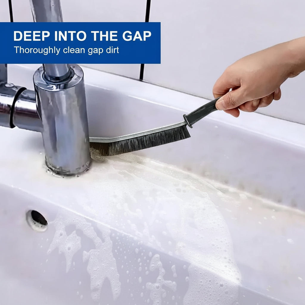 Gap cleaning brush in use on kitchen sink edges