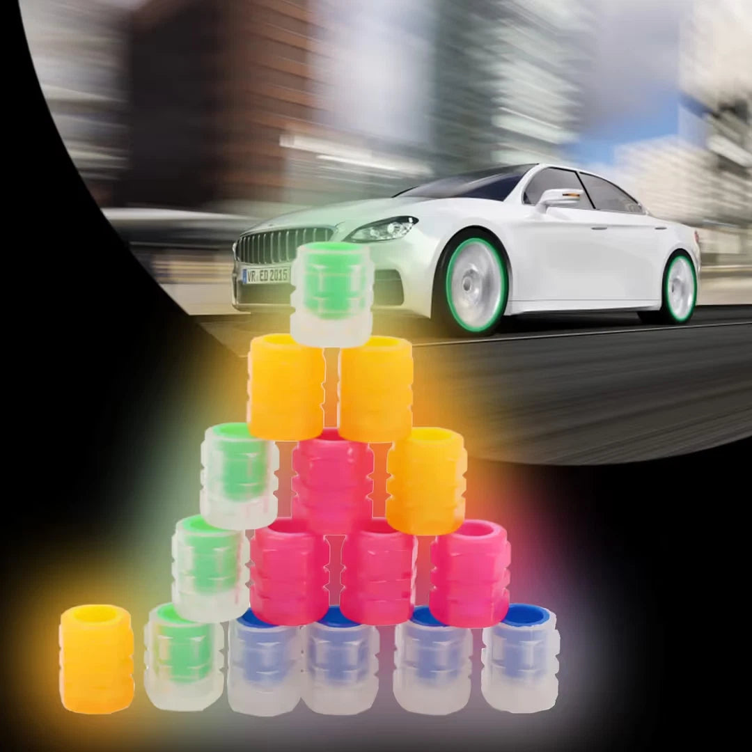 Luminous tyre valve caps glowing on car wheel at night