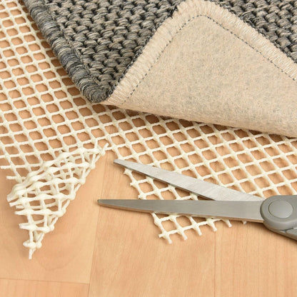 Rug stopper underlay placed on wood floor for safety and grip